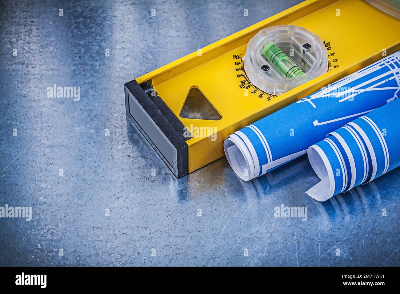 Blue engineering drawings construction level on metallic background