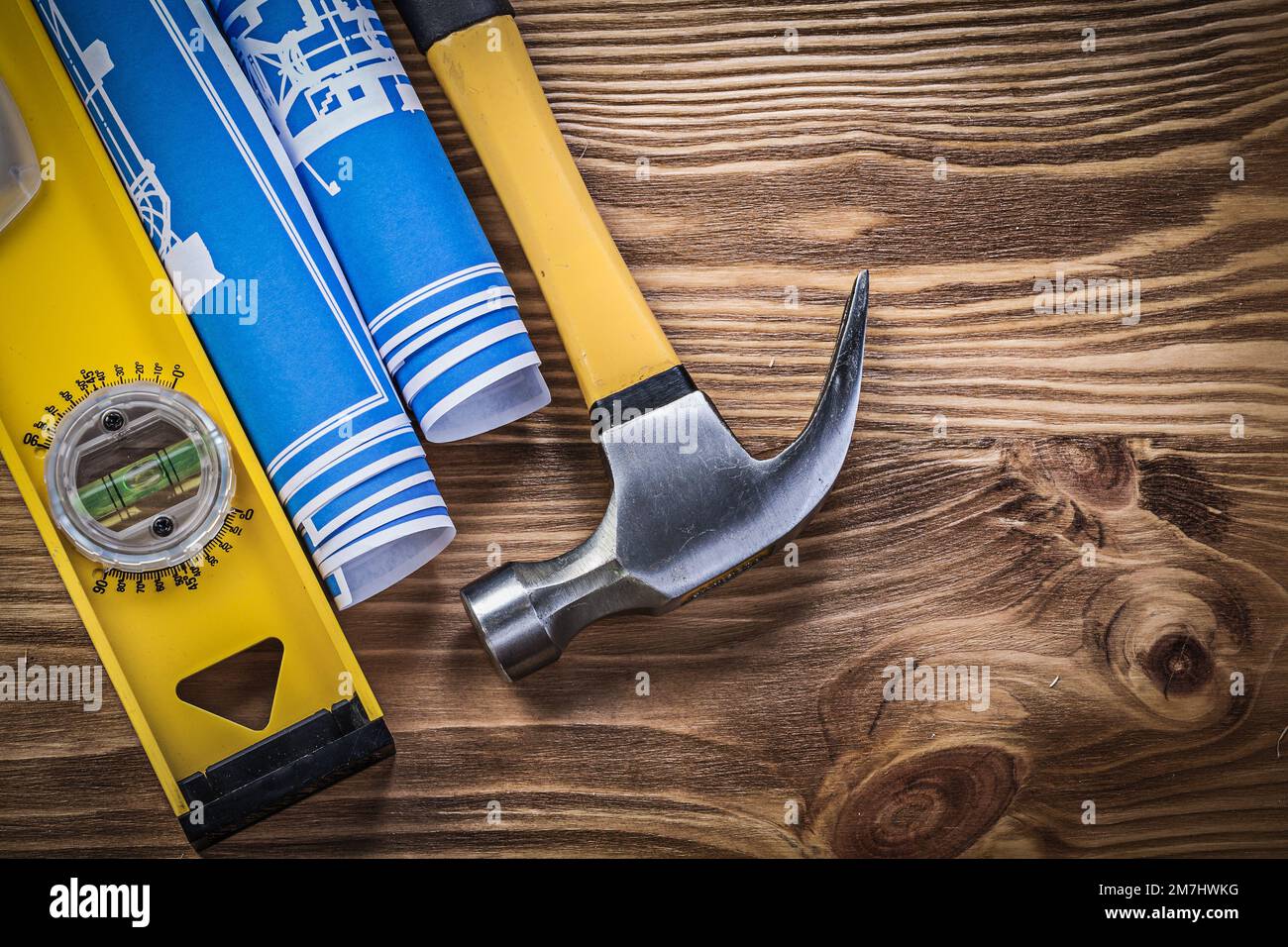 Blue engineering drawings construction level claw hammer on wooden ...