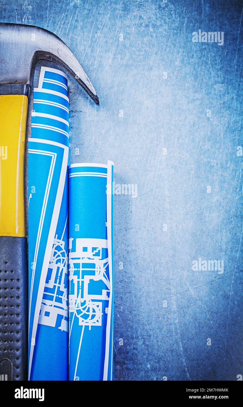Blue rolled blueprints claw hammer on metallic background Stock Photo ...