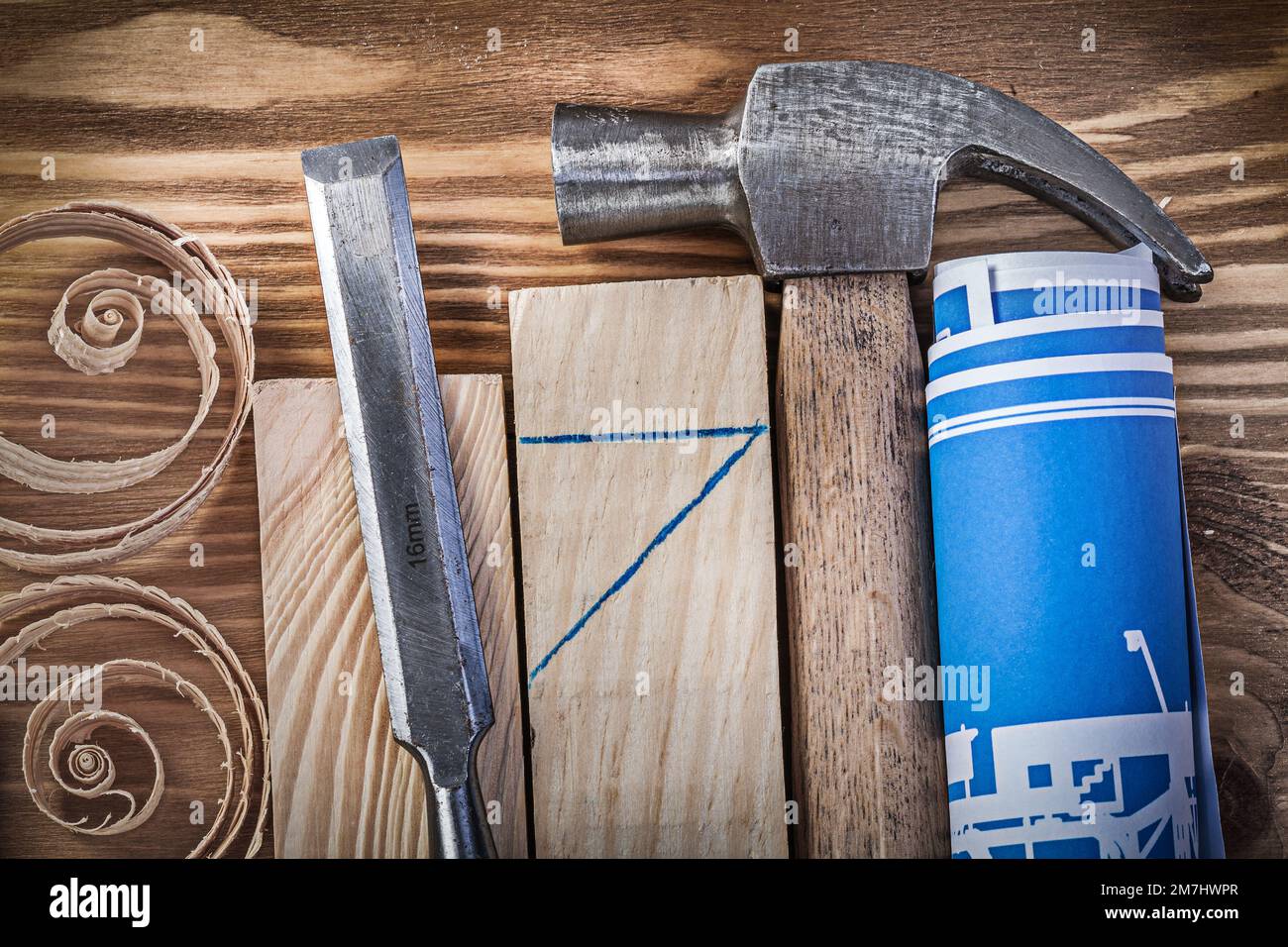 Blue rolled construction drawing claw hammer firmer chisel wooden studs