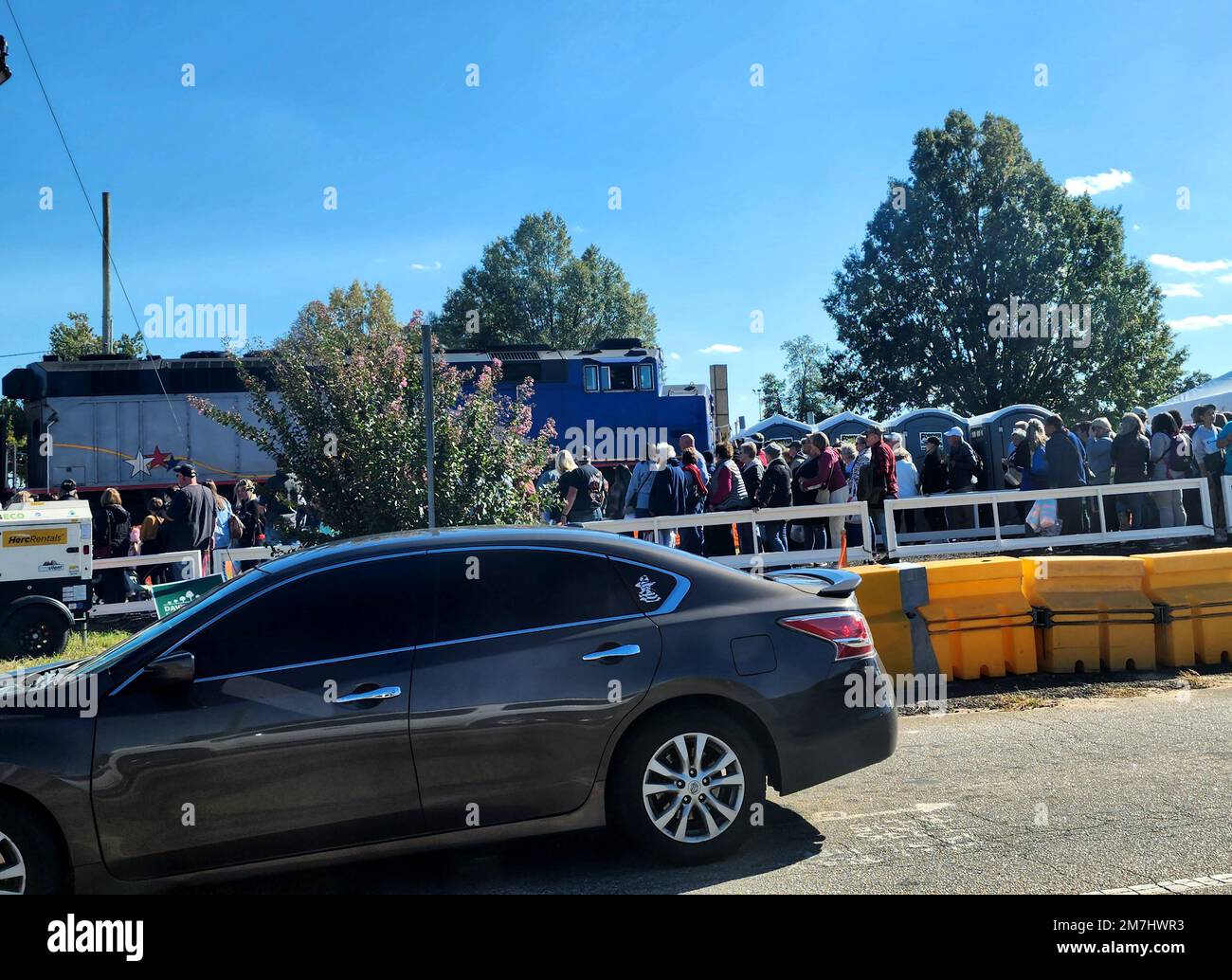 Fair grounds where a train has stopped to pick up people. A car is driving by to the fair grounds (NC State, October, 2022) Stock Photo