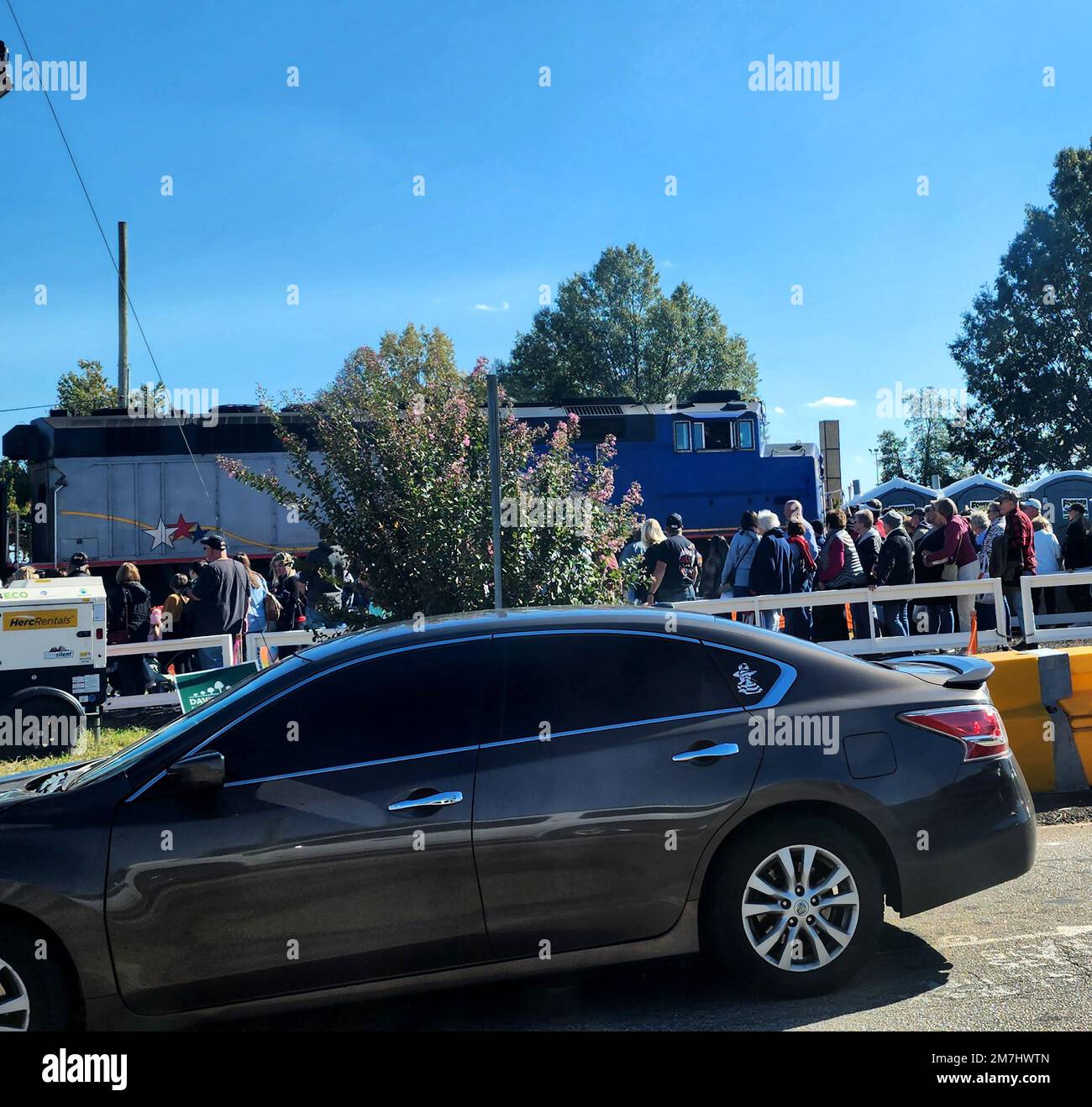 Fair grounds where a train stops to pick up people. A car is driving through (NC State, October, 2022) Stock Photo