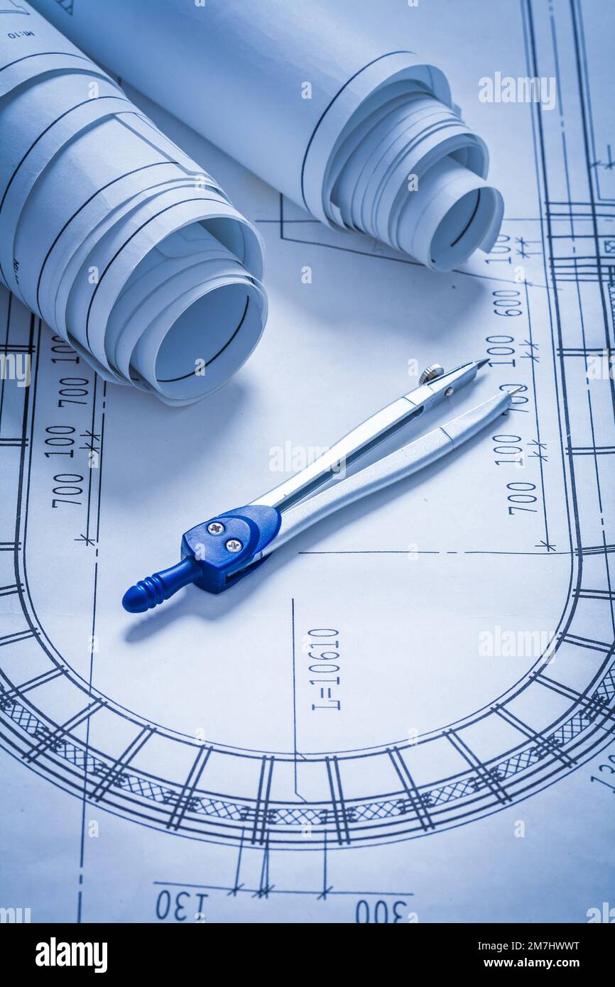 Blueprint rolls and pair of compasses construction concept Stock Photo