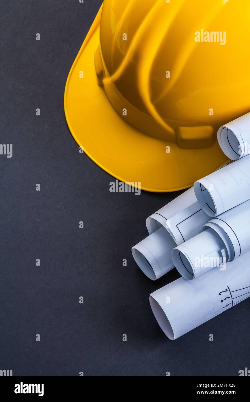 blueprints and helmet on black background Stock Photo - Alamy