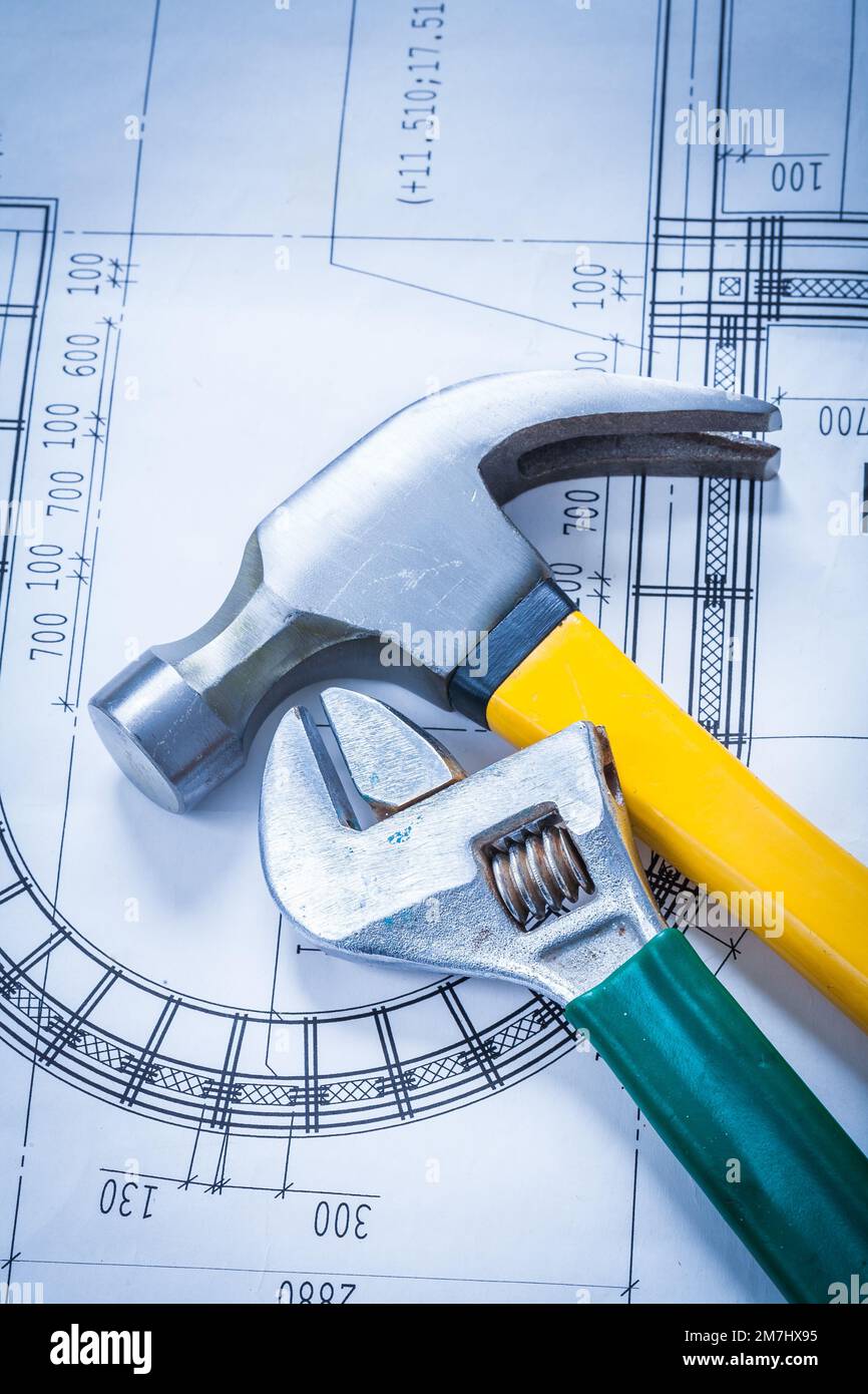 Claw hammer adjustable key on construction plan maintenance concept
