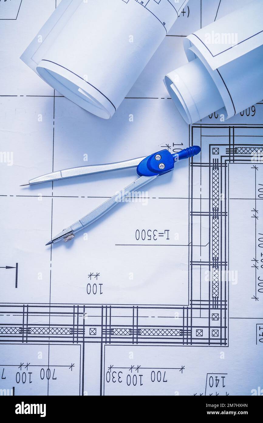 compass and two rolled up white blueprints Stock Photo - Alamy