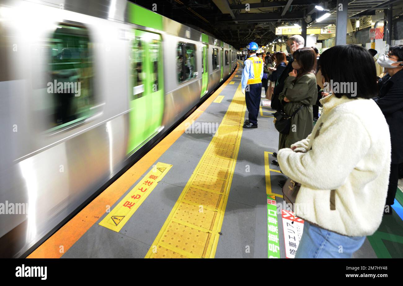 Japanese passengers waiting for the JR Yamanote line in Tokyo, Japan