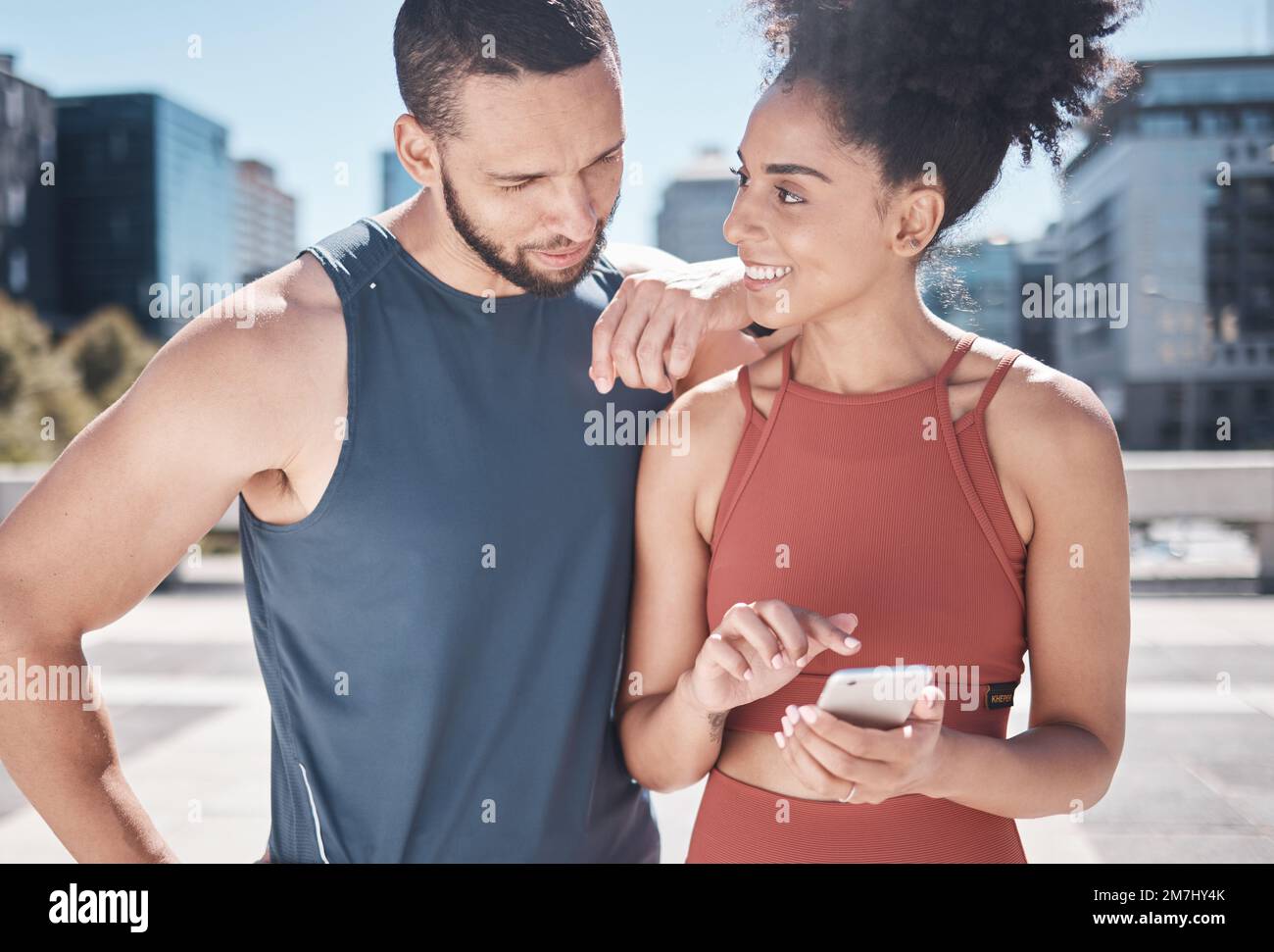 Fitness, city and black couple with phone for workout, running exercise and marathon training. Love, sports and man and woman on smartphone for social Stock Photo