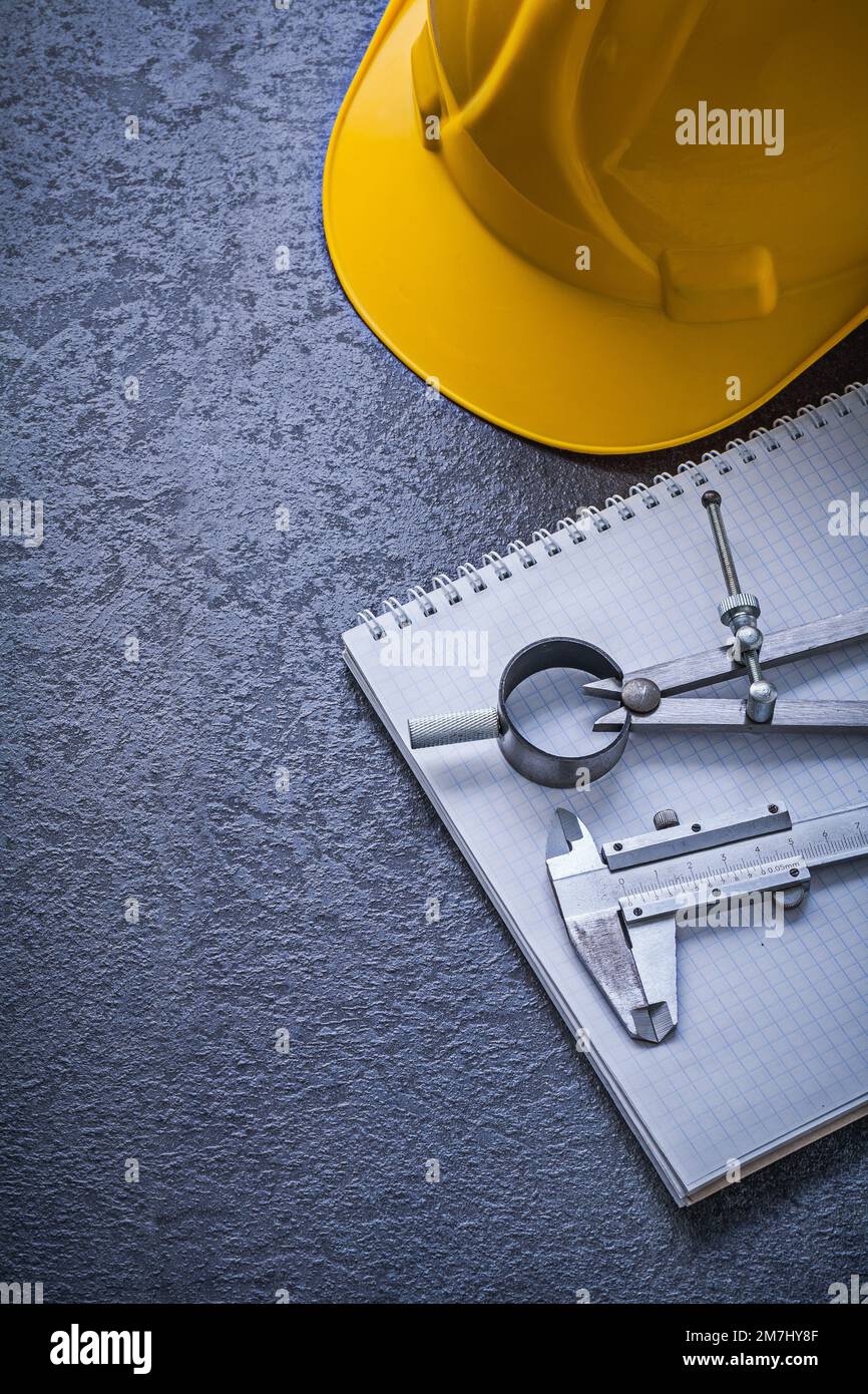Copybook hard hat drawing compass vernier scale construction concept. Stock Photo