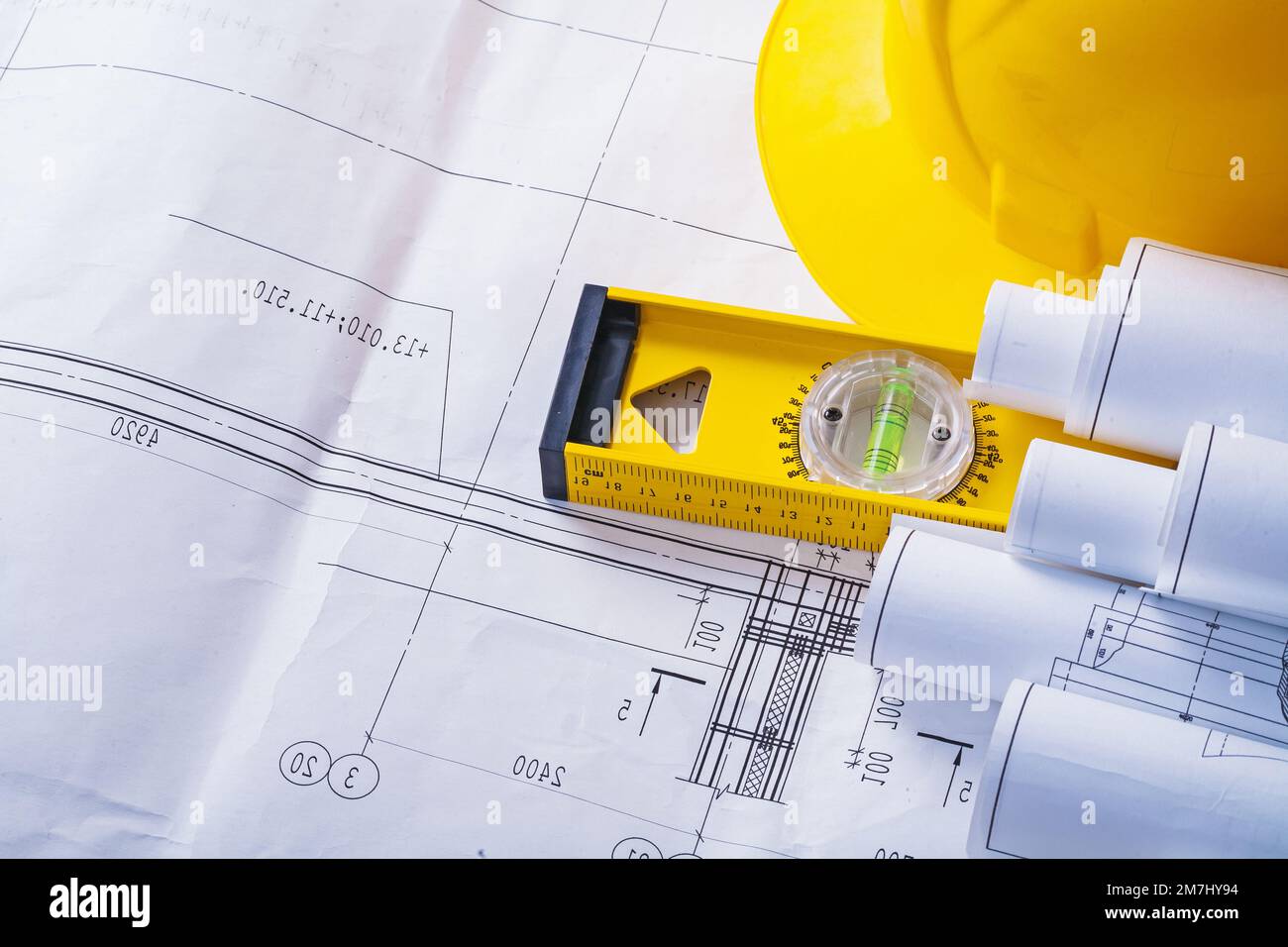 copyspace image rolled blueprints level helmet Stock Photo - Alamy