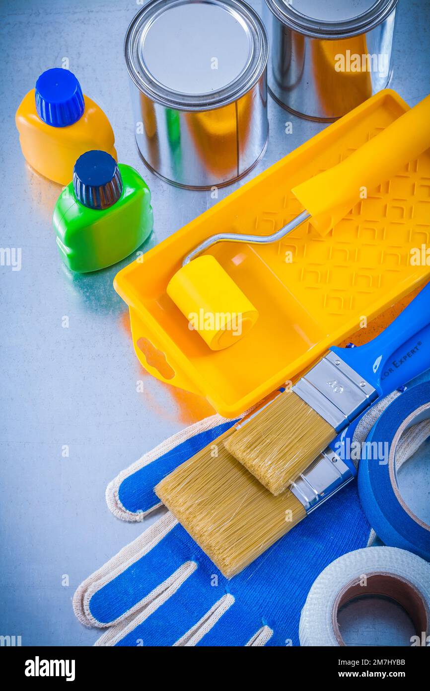 Duct tapes protective gloves paint brushes roller tray cans and bottles