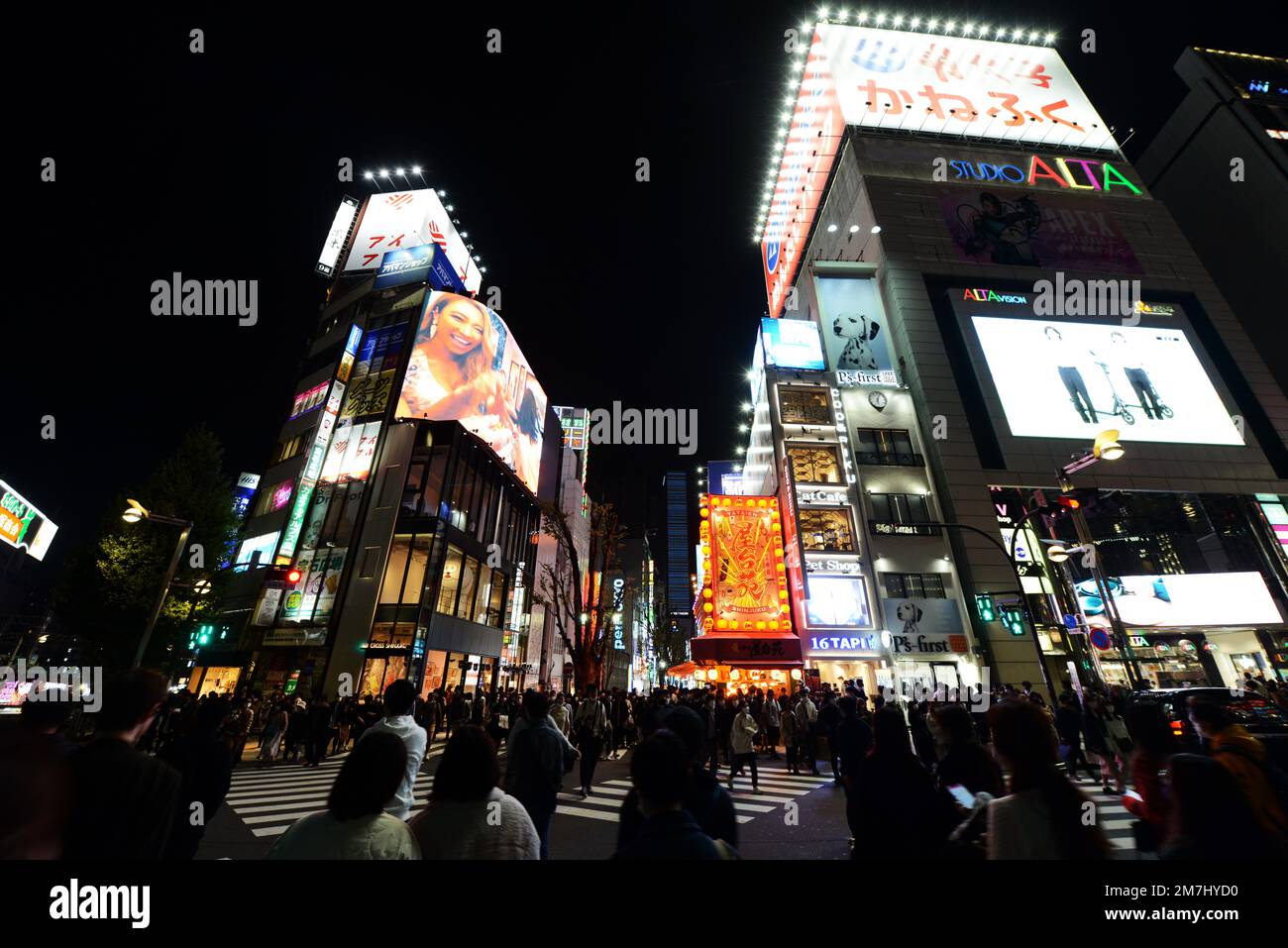Pedestrians crossing towards Kabukicho entertainment district in Shinjuku, Tokyo, Japan. Stock Photo