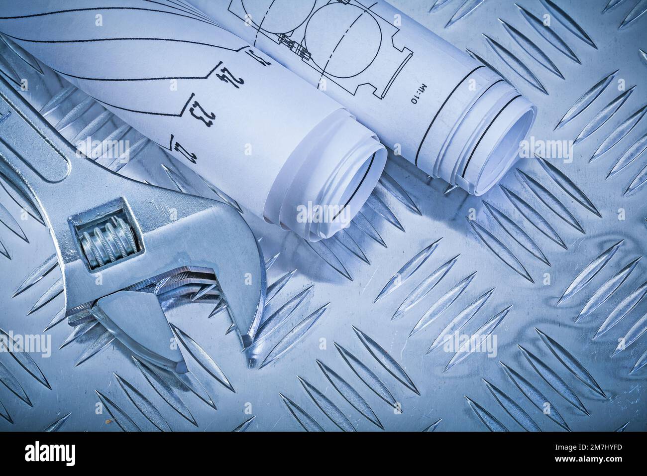 Engineering drawings monkey spanner on fluted metal sheet construction