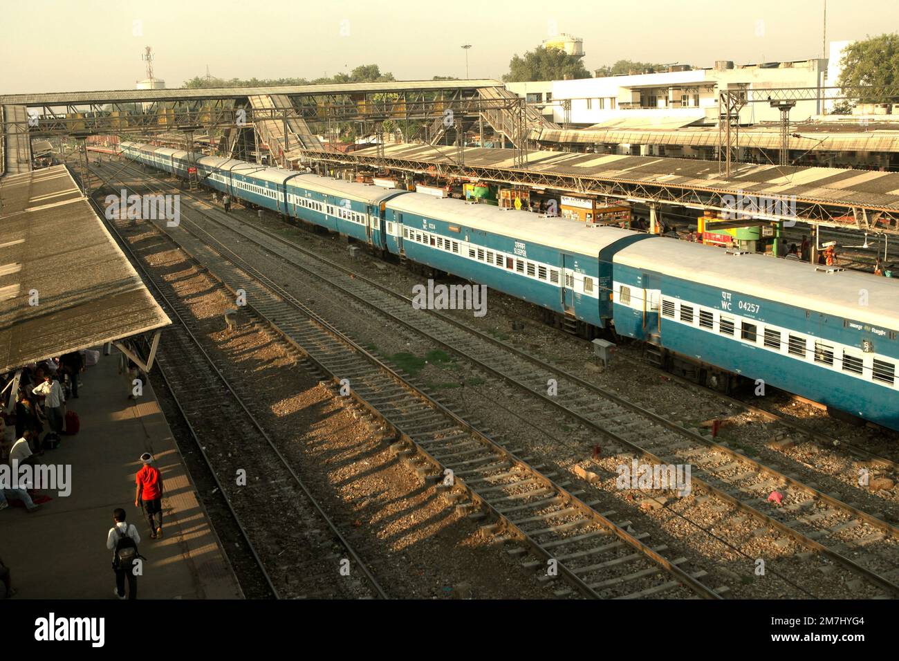 Railroad tracks, train, and morning view of New Delhi Railway Station