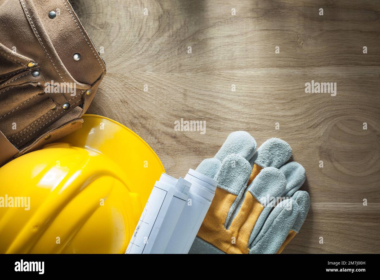 Leather tool belt construction plans safety gloves hard hat Stock Photo