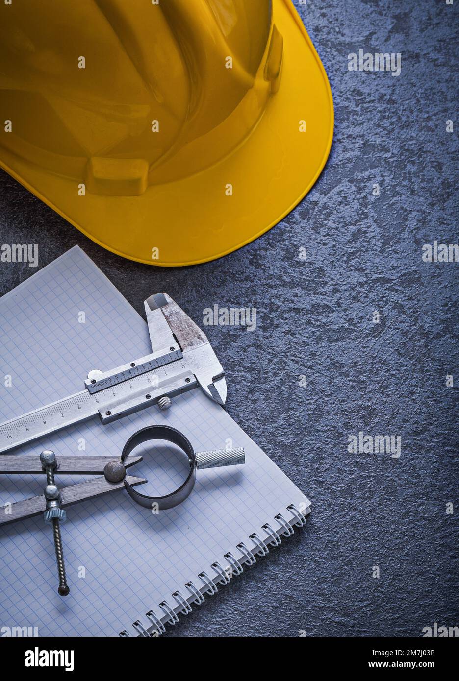 Notebook building helmet drawing compass vernier scale construction concept. Stock Photo
