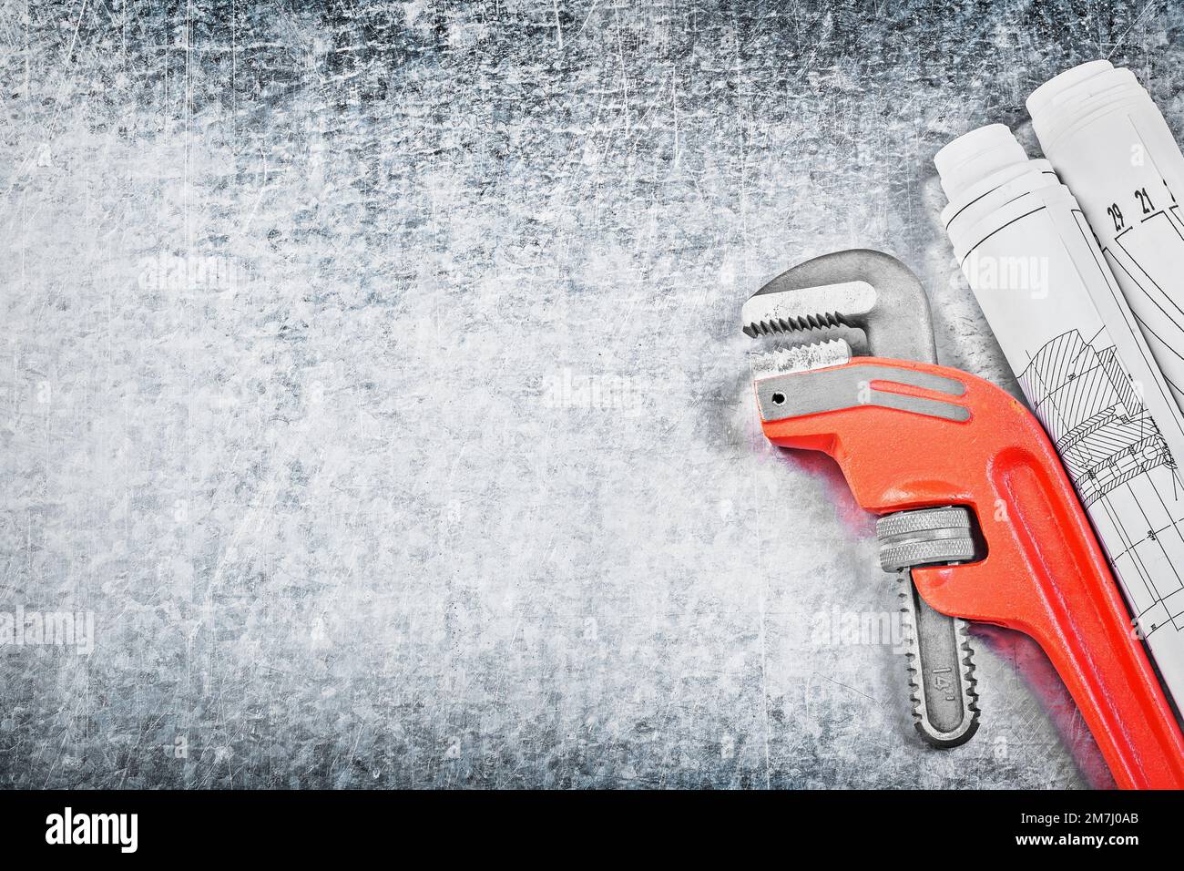 Pipe wrench blueprints on metallic background copy space construction concept. Stock Photo