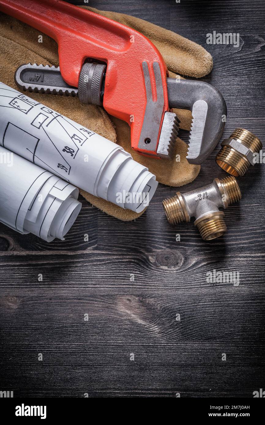 Pipe wrench brass plumbing fittings protective gloves blueprint rolls ...