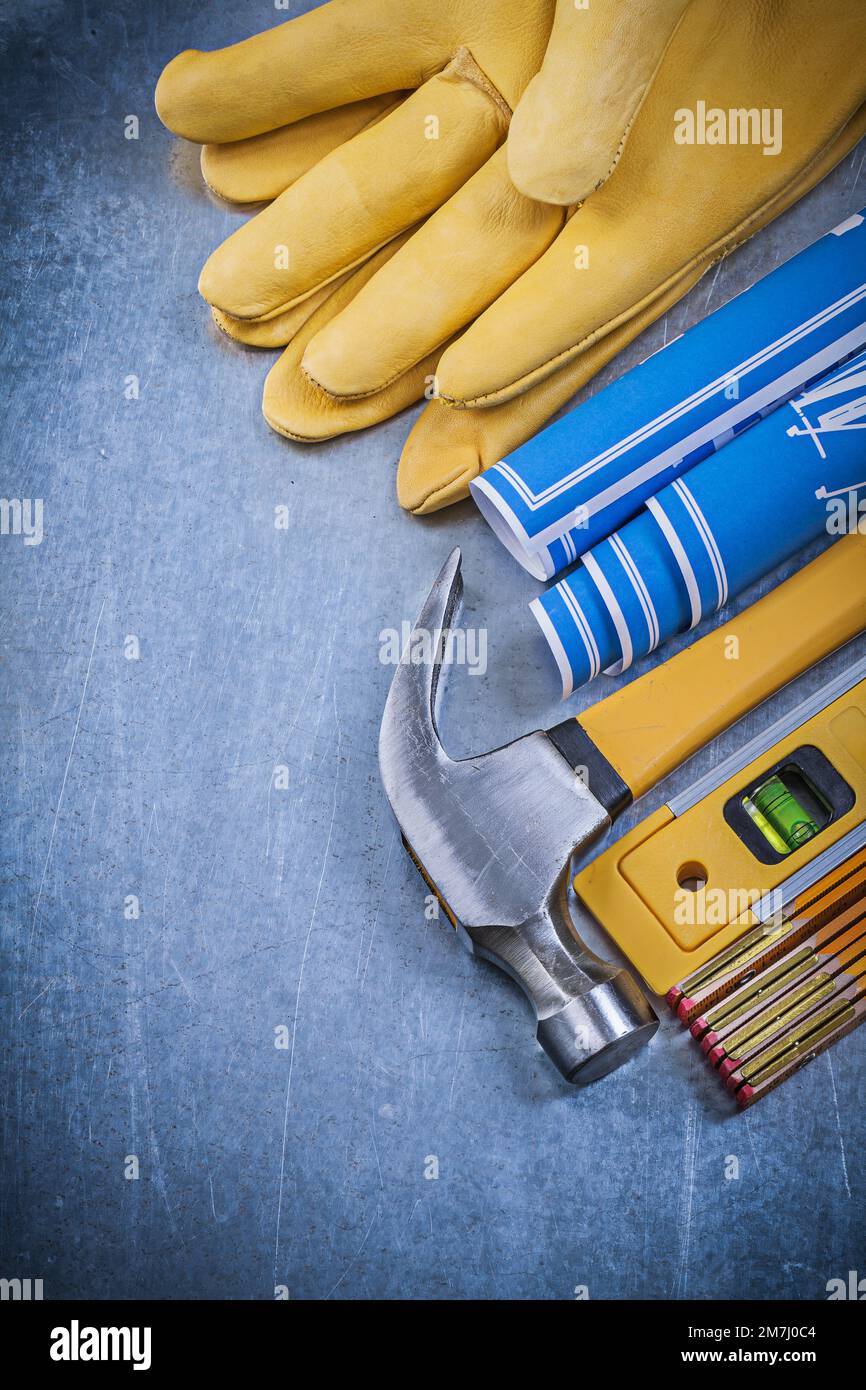 Protective gloves blue blueprints claw hammer construction level wooden ...