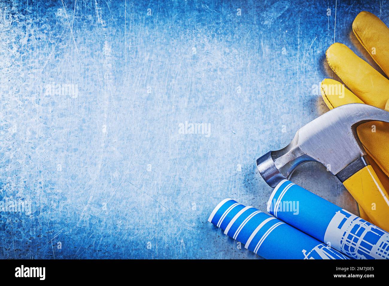 Protective working gloves blue rolled construction drawings claw hammer ...