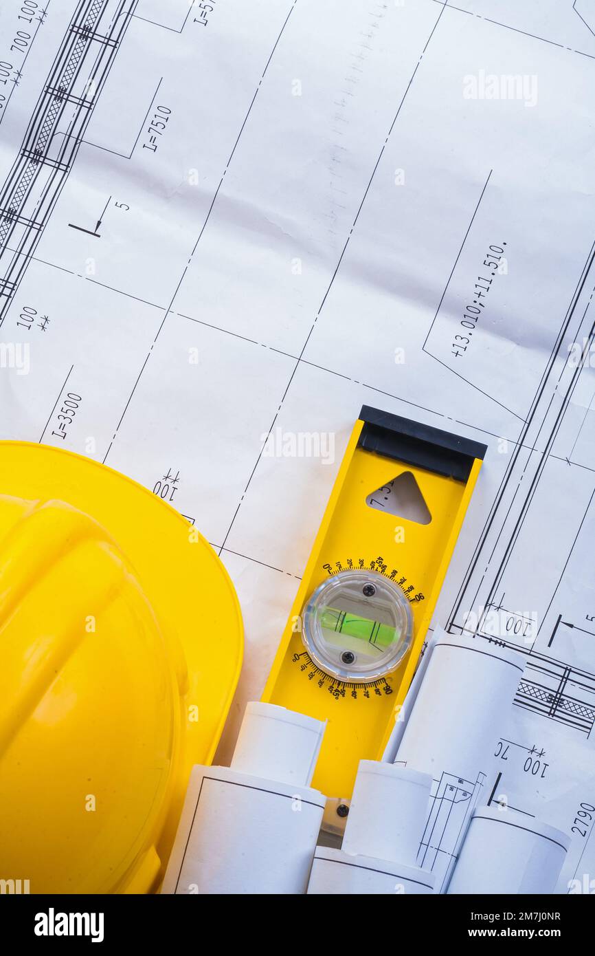 rolled blueprints helmet level Stock Photo - Alamy