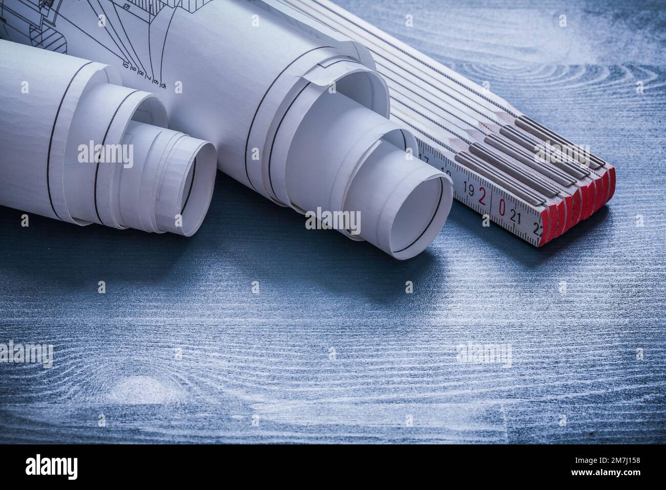 rolls of blueprints and wooden meter Stock Photo - Alamy