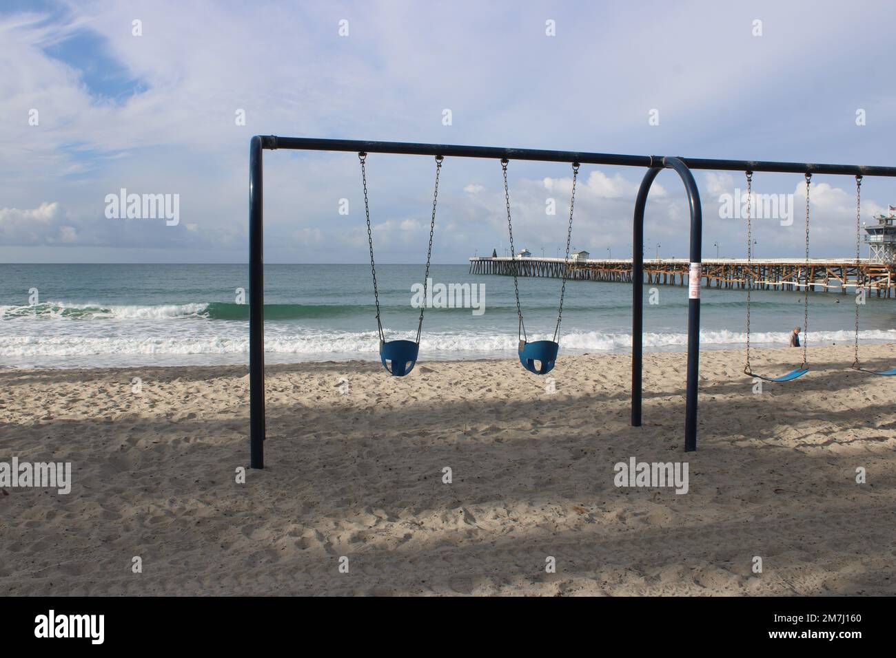 Empty children's swing set on San Clemente State Beach, California Stock Photo