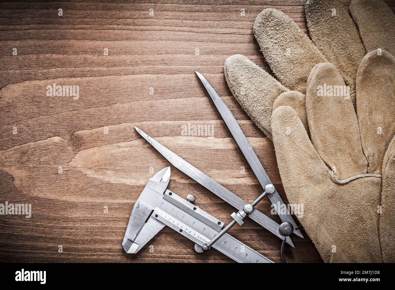 Slide caliper drawing compass safety gloves construction concept Stock