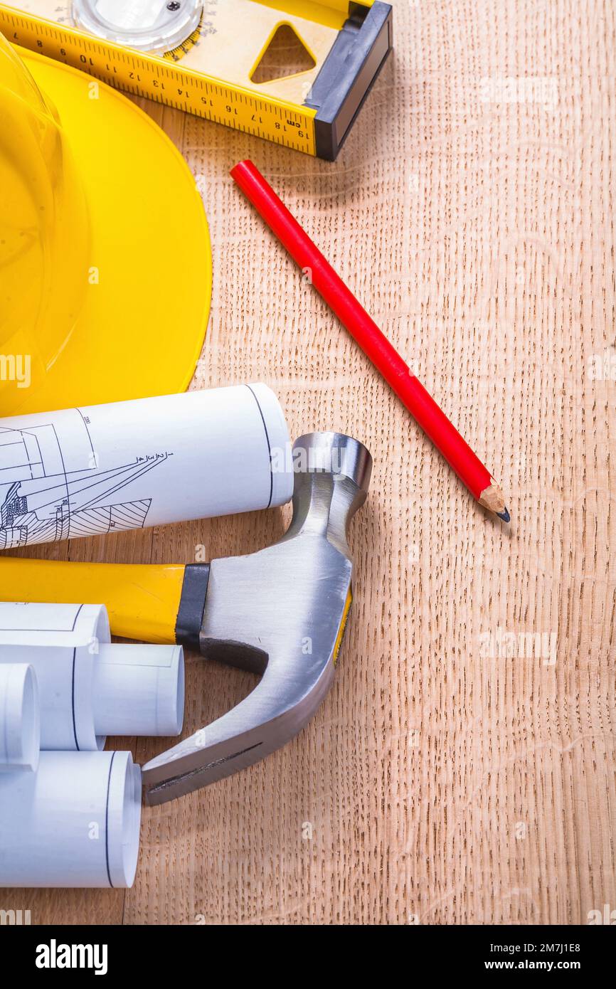 set of tools rolled blueprints claw hammer pencil hardhat level Stock