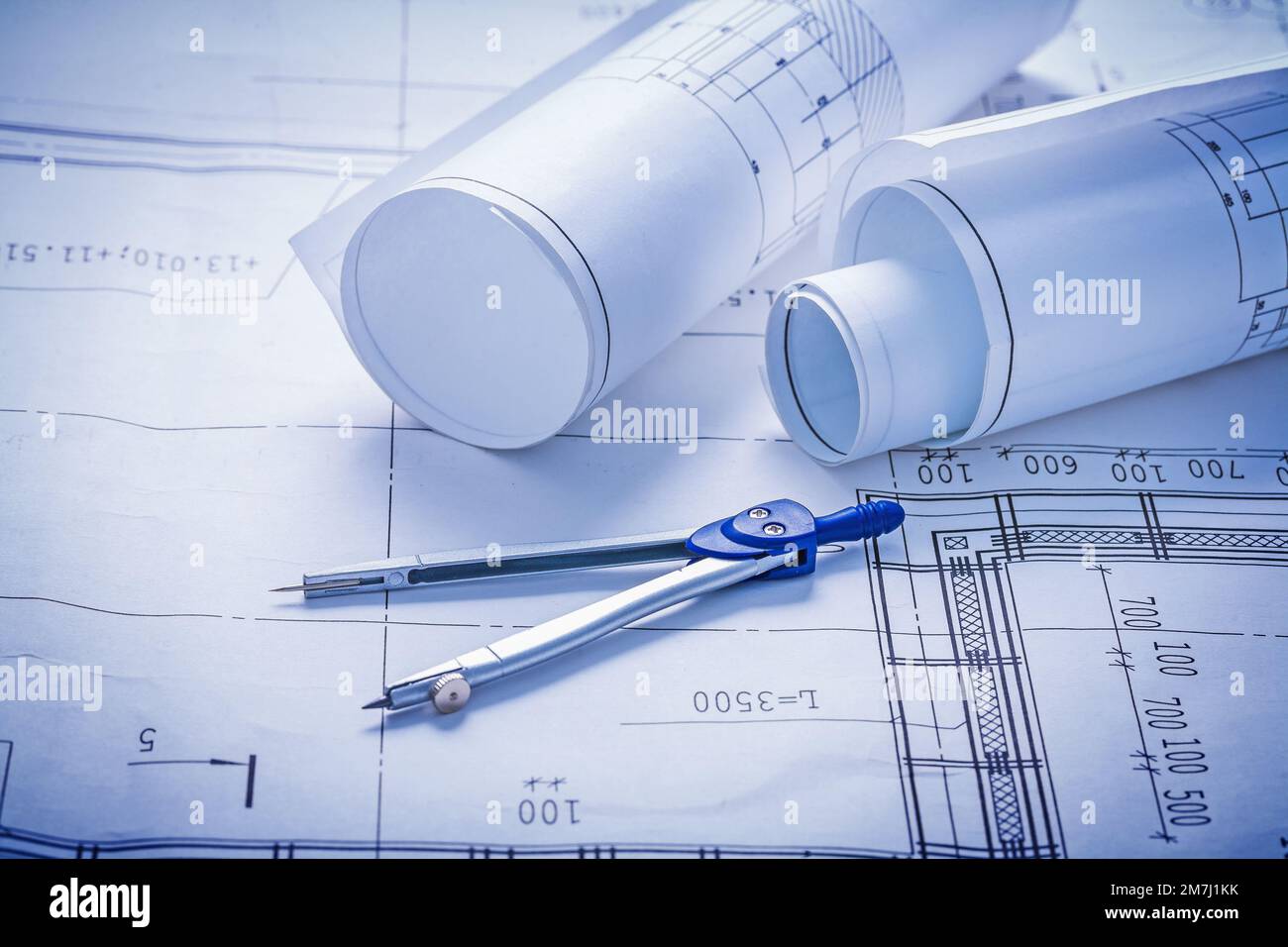 two rolled up blueprints and compass construction concept Stock Photo
