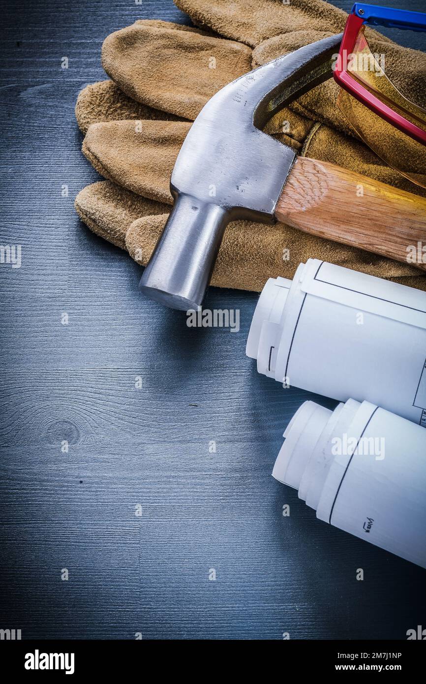 vertical view rolls of blueprints hammer gloves goggles Stock Photo - Alamy