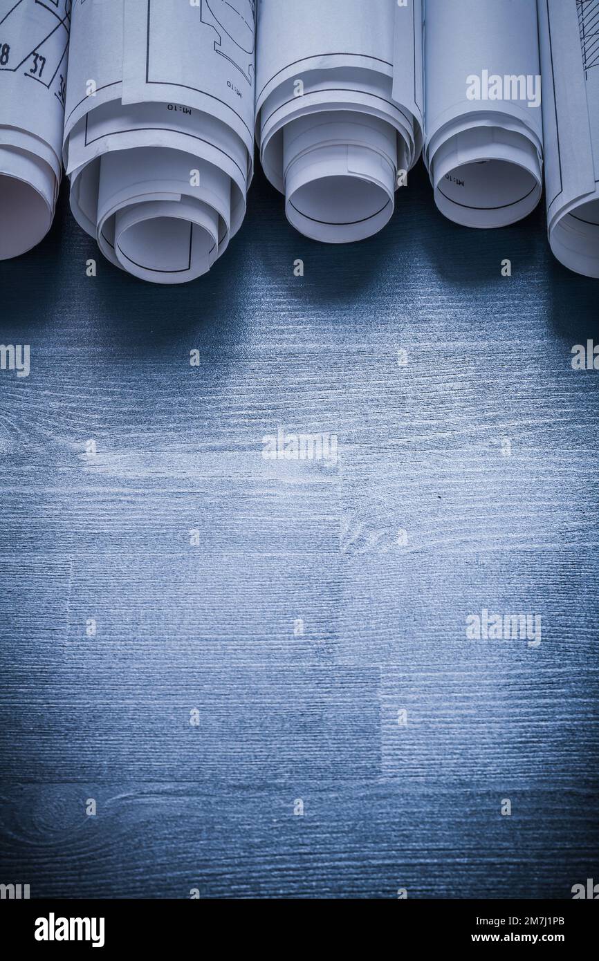 vertical view row of blueprints rolls on painted board Stock Photo - Alamy