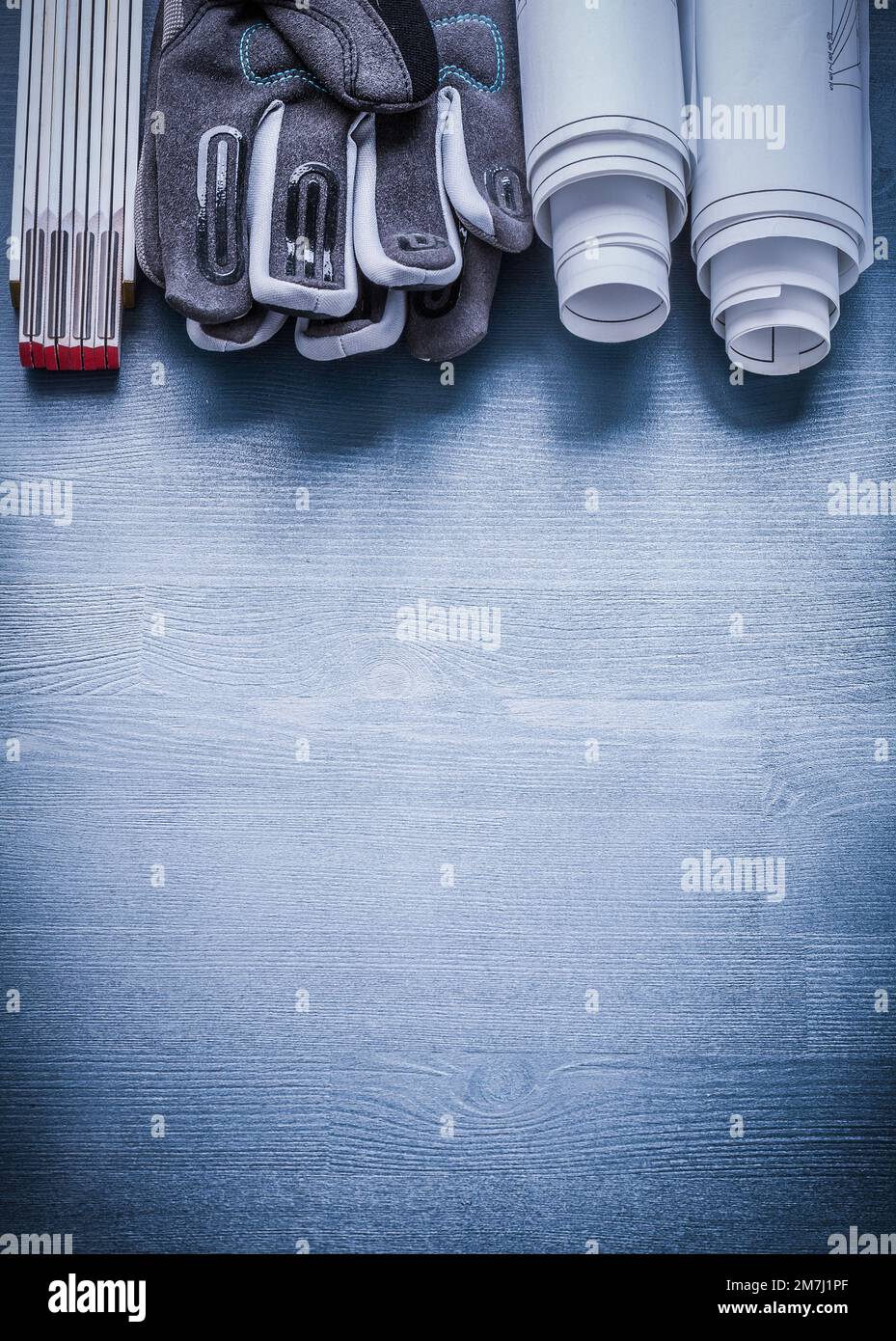 vertical view two rolls blueprints safety gloves wooden meter Stock ...