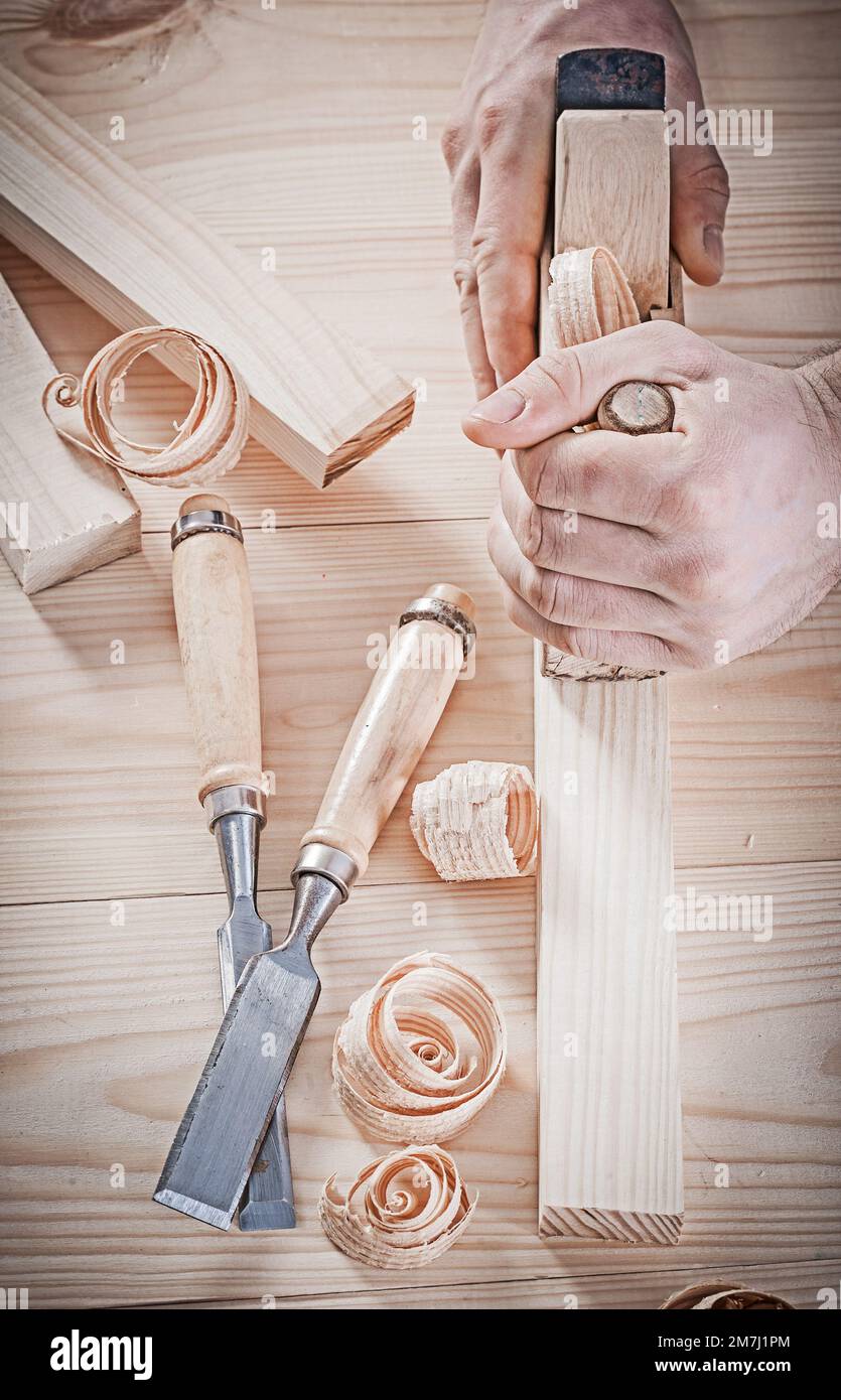 very close up view on work with woodworking plane. Stock Photo