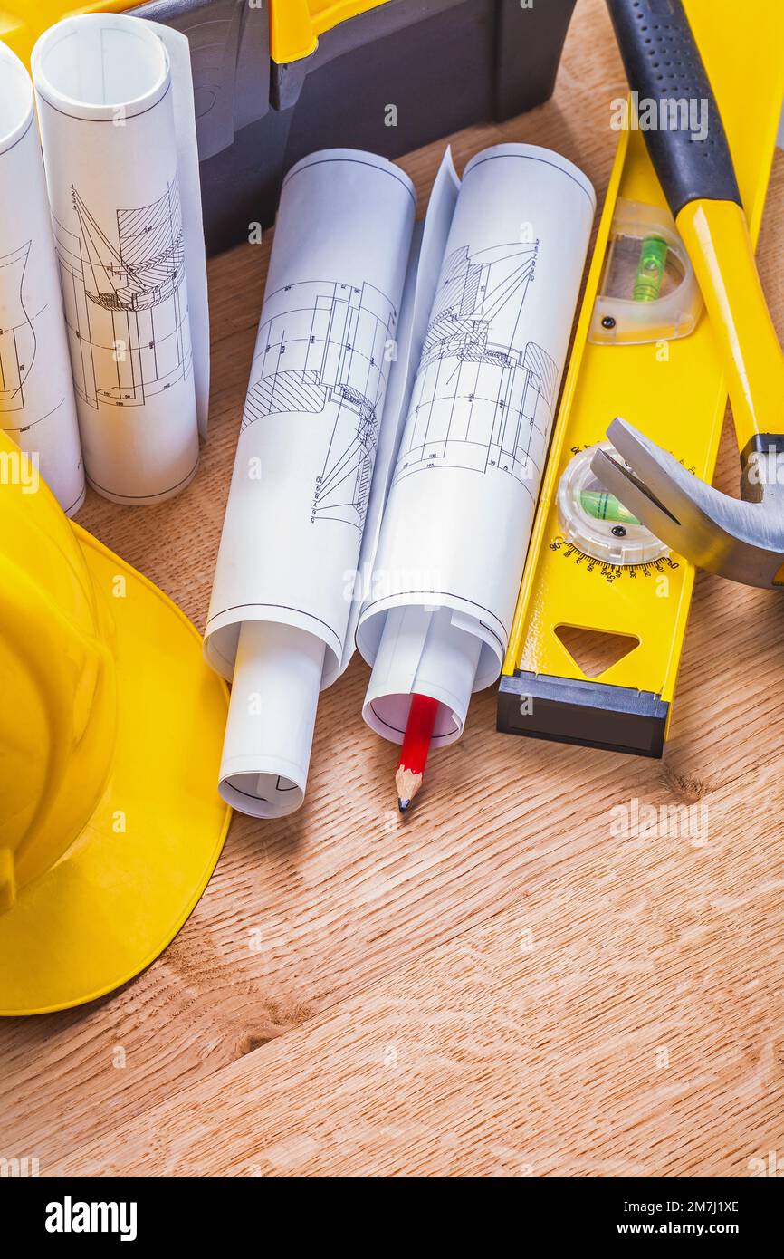 white rolled up blueprints hammer level helmet on wooden boards Stock ...