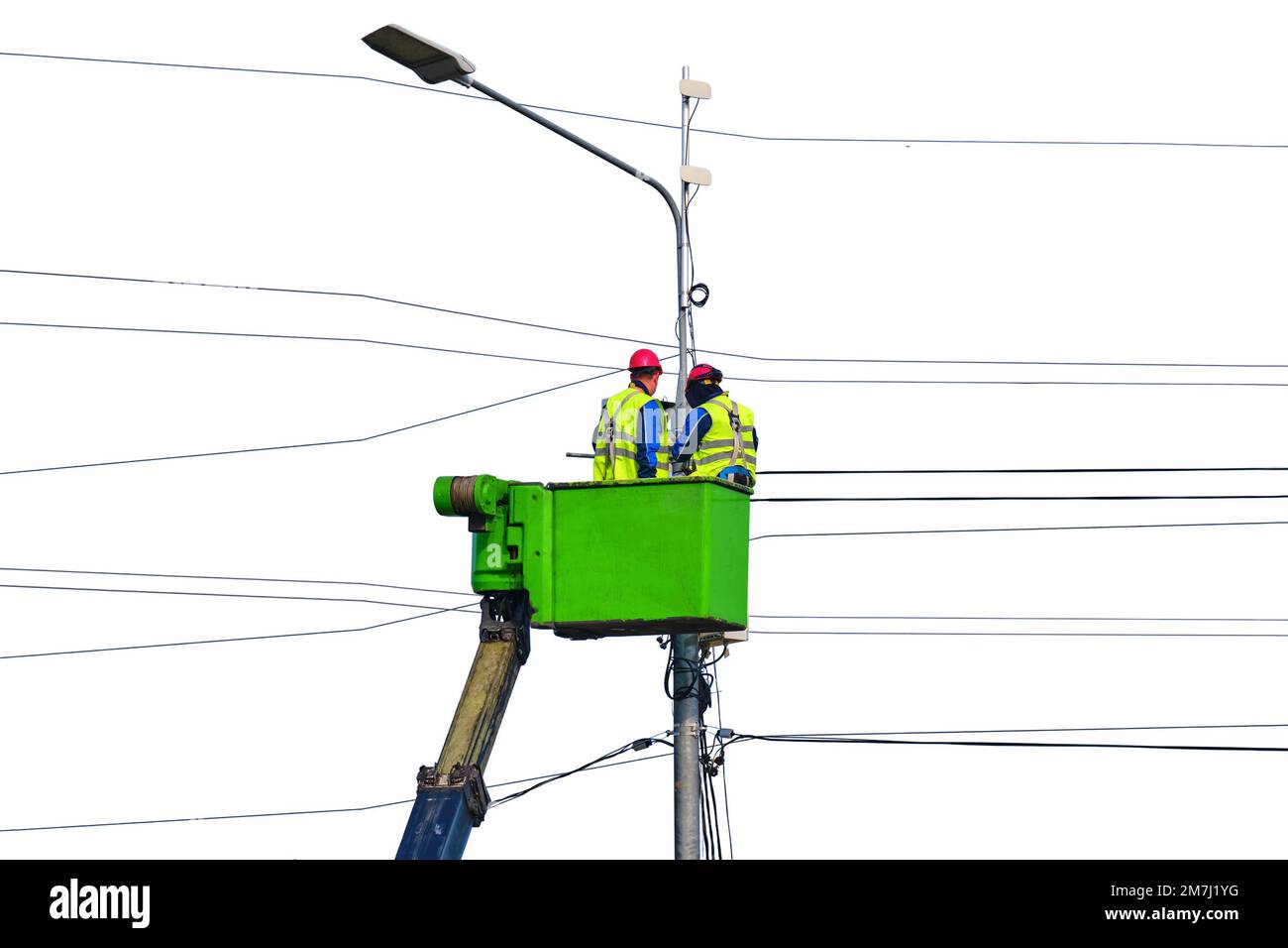Electrical engineers repair the line standing on the crane platform at