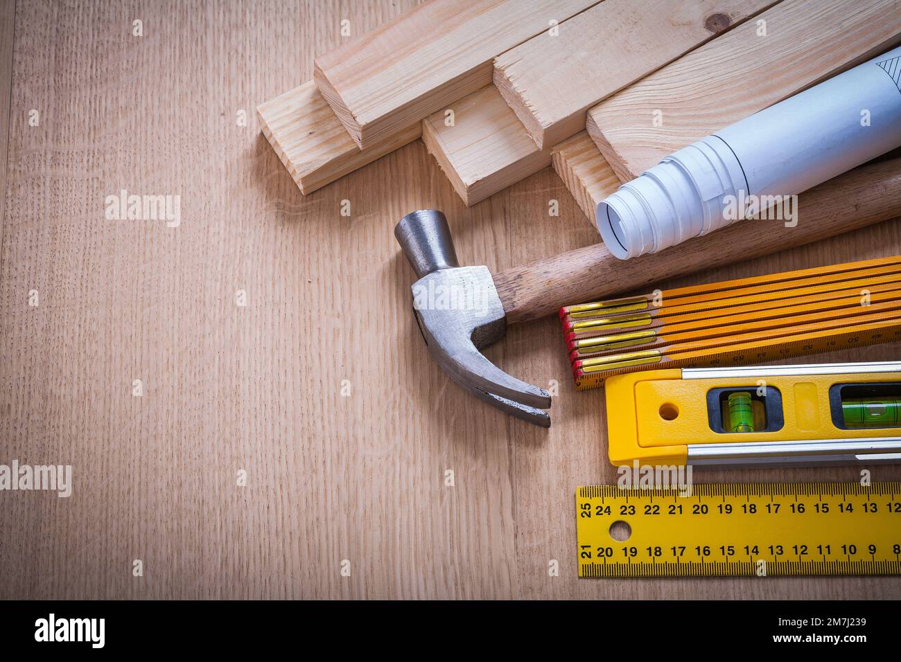 Wooden studs and meter ruler hammer blueprints construction level on ...