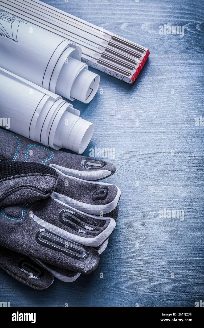 working glove rolled blueprints and wooden meter Stock Photo - Alamy