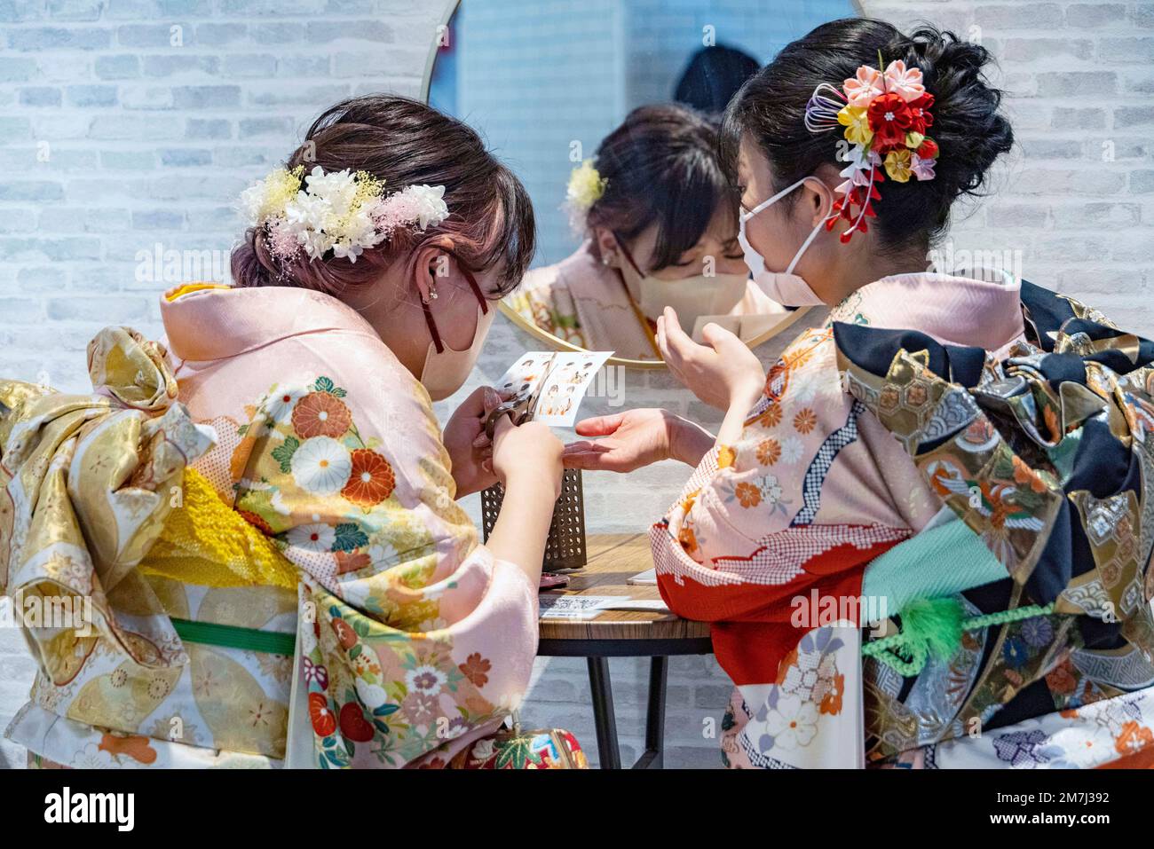 pic shows:  Coming of Age day in Fukuoata, Japan.  Young women in kimonos celebrate the coming of age by going to photo booths in local shopping centr Stock Photo