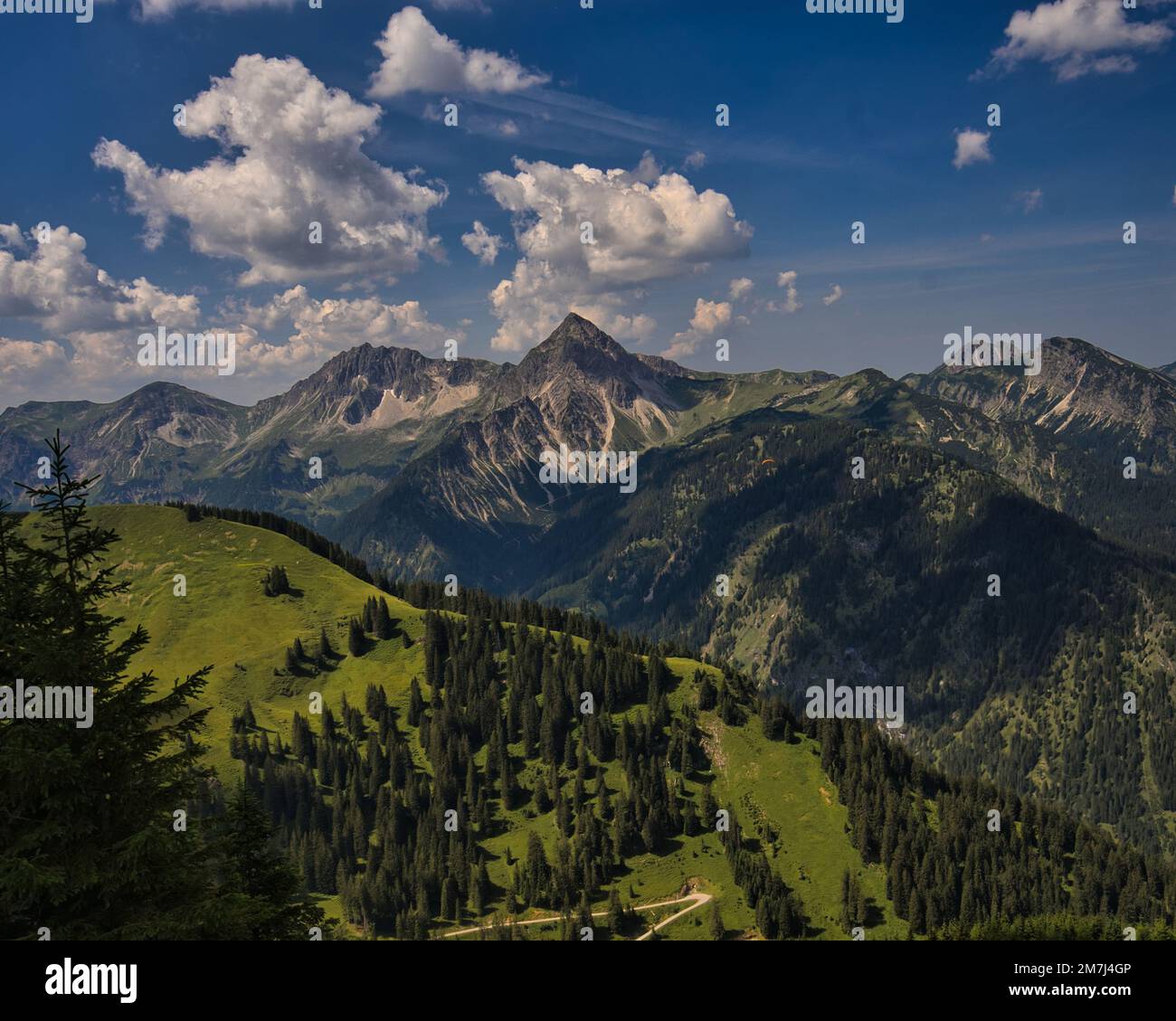 A bird's eye view of a mountain range covered with green forests under ...