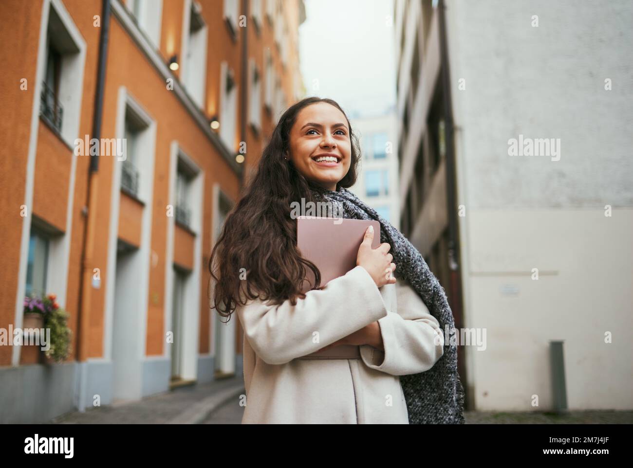 Travel, tourism and journal with a sightseeing woman tourist in the city traveling for global vacation. Thinking, book and traveling with a young Stock Photo