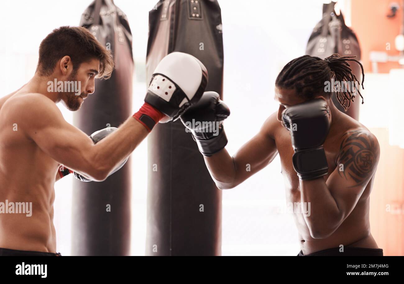Boxing opponents and friends. a young boxer practicing his punching ...