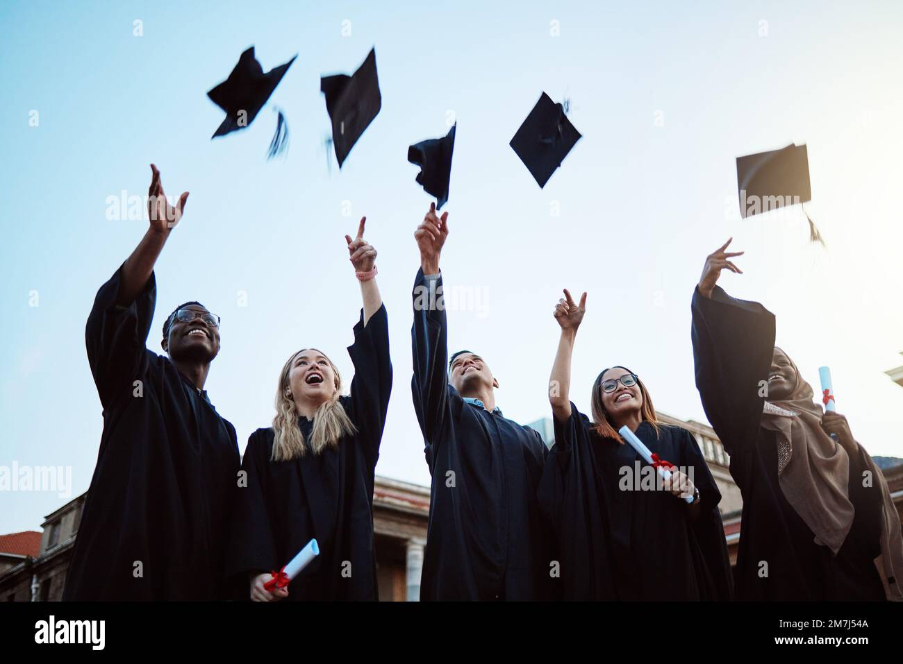 Graduation, education and success with friends in celebration as a ...
