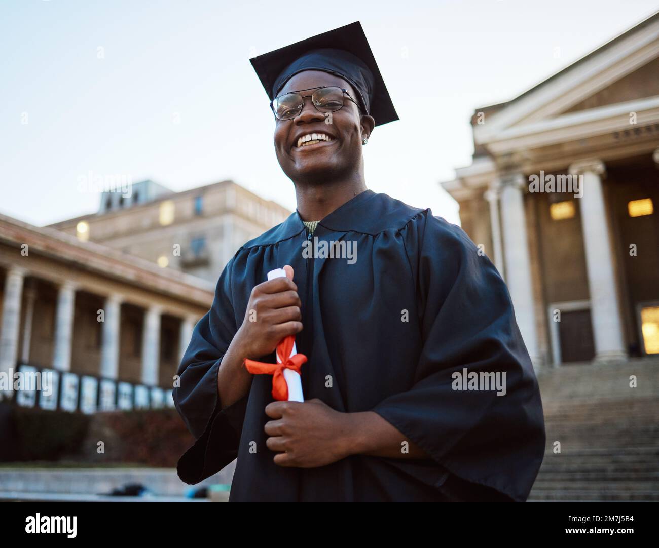 University diploma, graduation and portrait of a black man at campus to celebrate success in school. Scholarship, pride and African student with Stock Photo