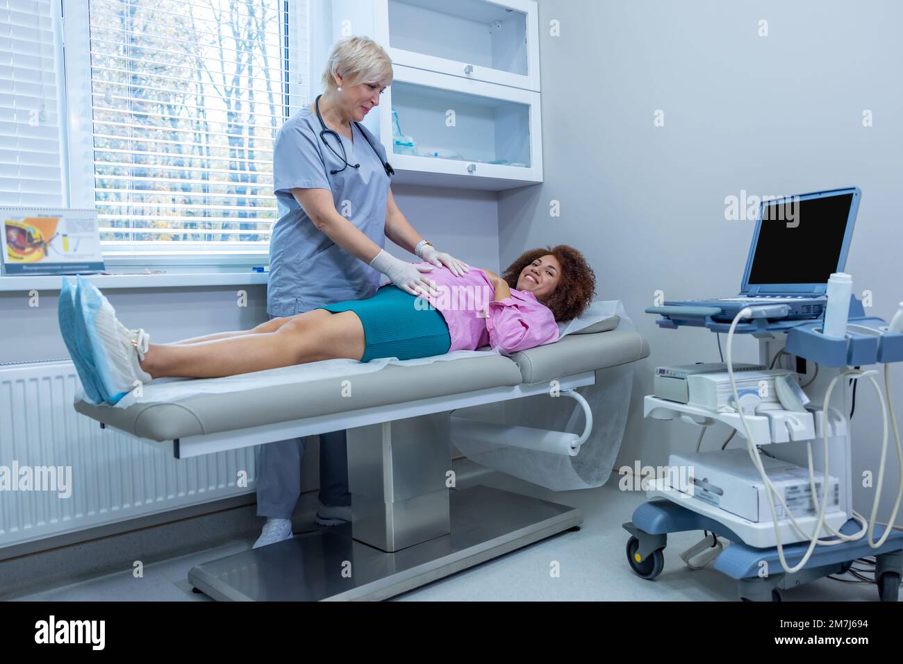 Palping Obstetrician examining the pregnant woman and palping her belly Stock ...