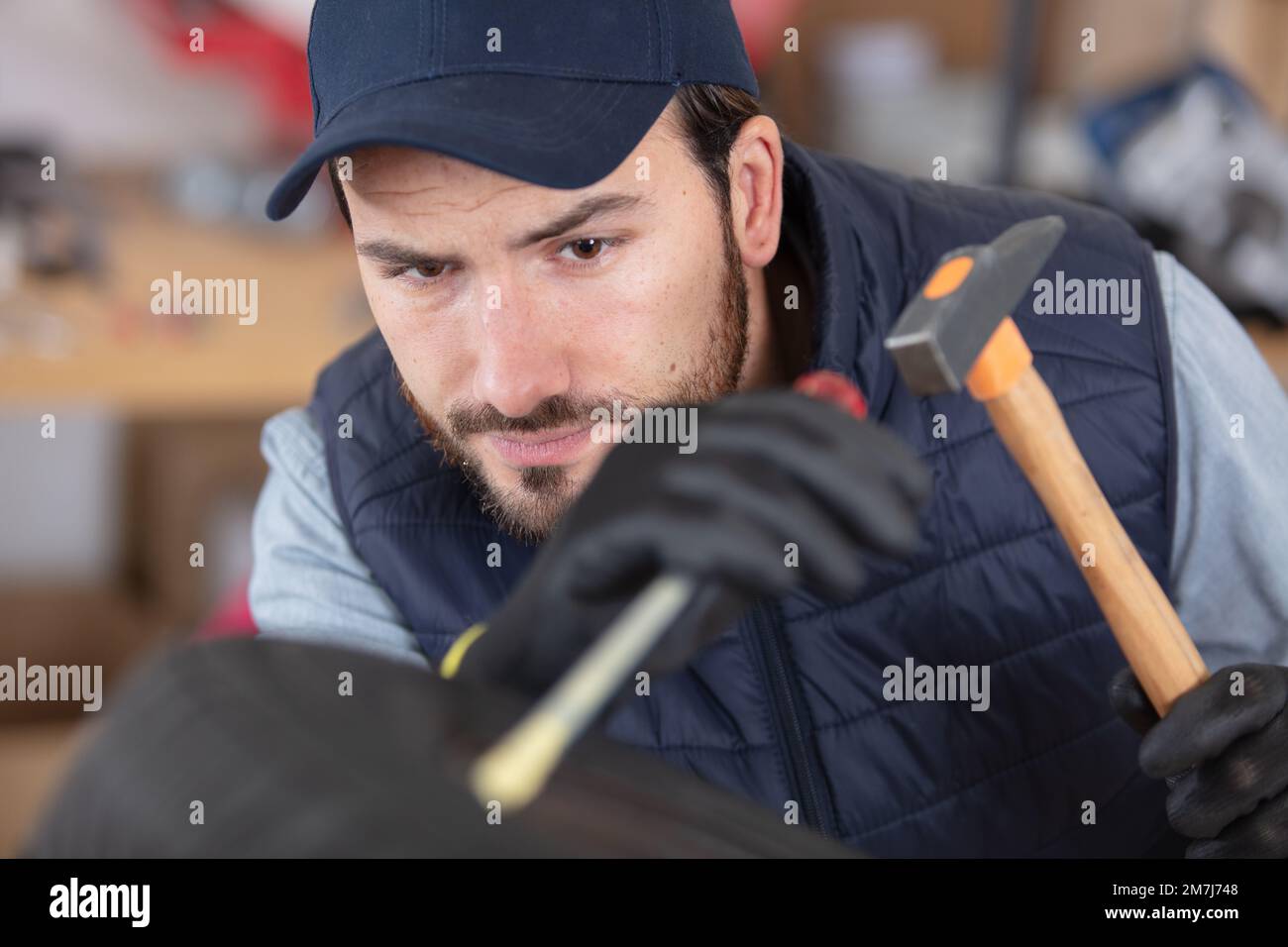 car mechanic using hammer at the garage Stock Photo Alamy