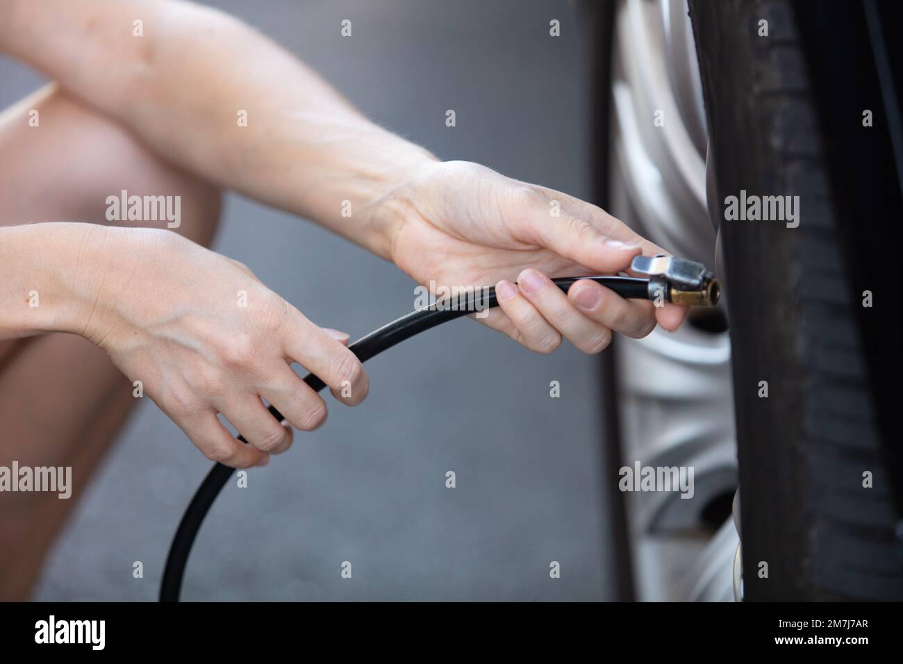pumping air into auto wheel Stock Photo Alamy