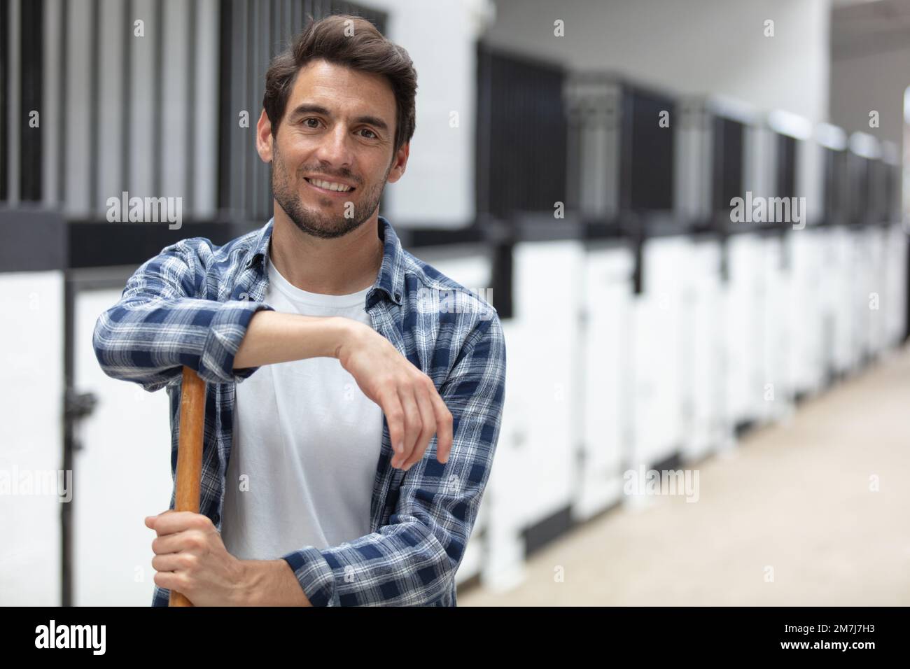 smiling man with herd of cows in cowshed on dairy-farm Stock Photo - Alamy
