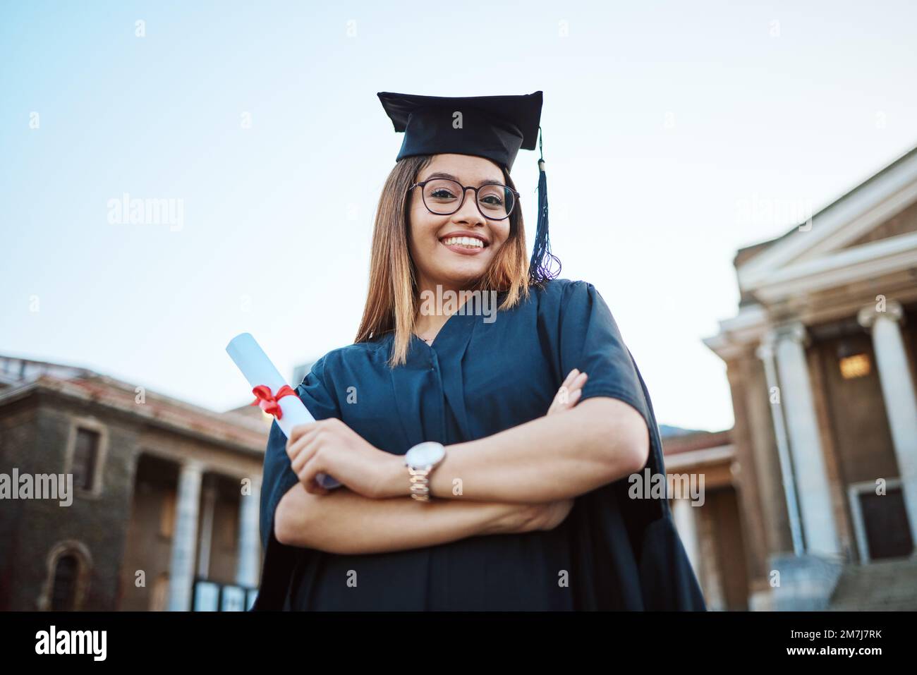 Portrait, graduation and education with a student woman holding a diploma or certificate outdoor as a graduate. Study, goal or unviersity with a Stock Photo