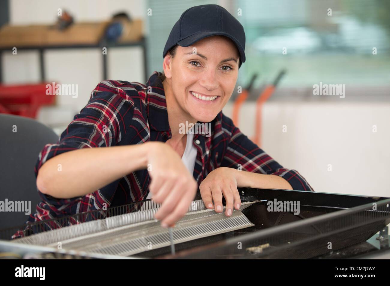 feman technician during television repairs Stock Photo